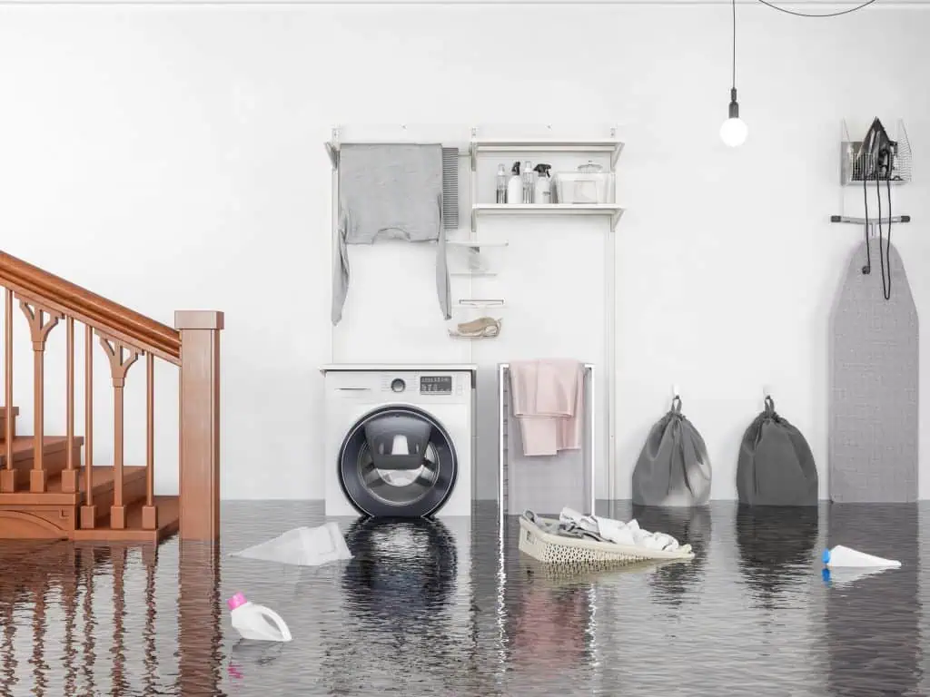 Flooded laundry room with water covering the floor