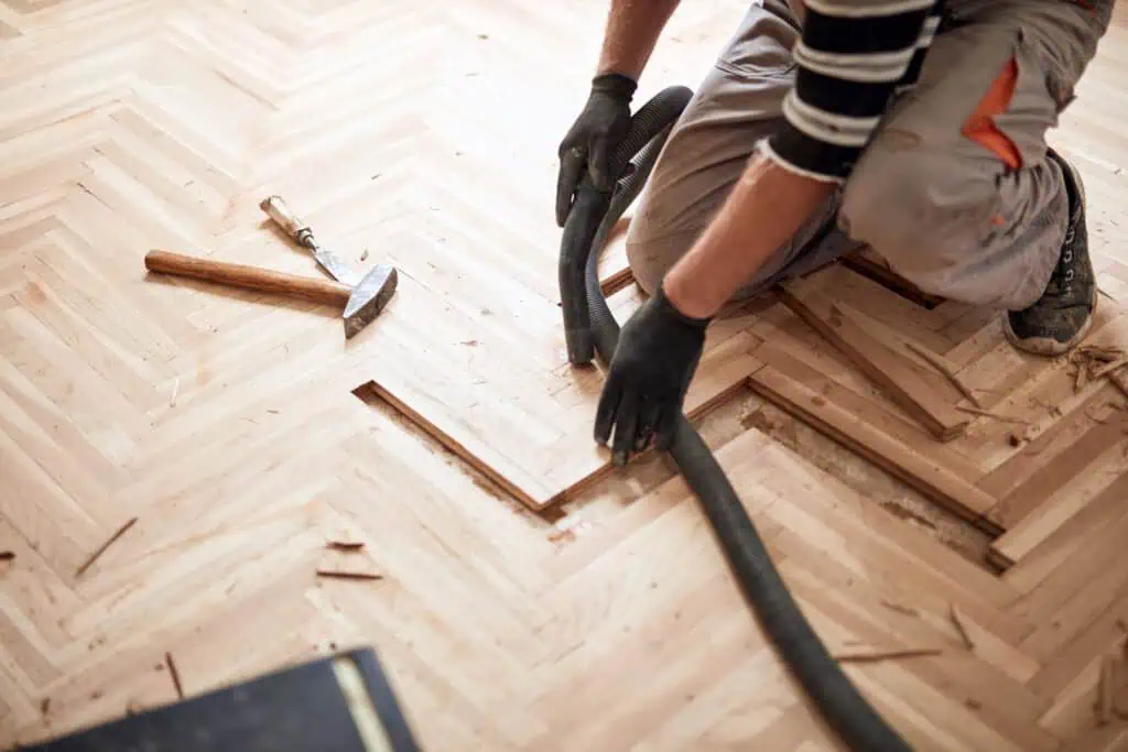 Technician repairing a herringbone hardwood floor
