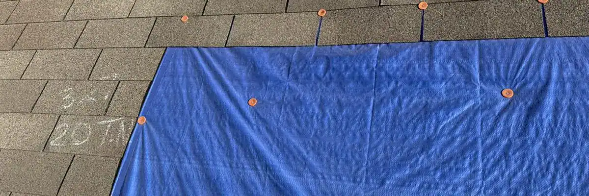 Emergency roof repair using tarp for storm damage by Dolan Roofing & Construction in San Antonio