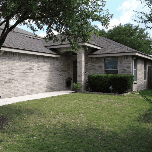 Front view of completed roof and gutter system upgrade by Dolan Roofing & Construction in Helotes