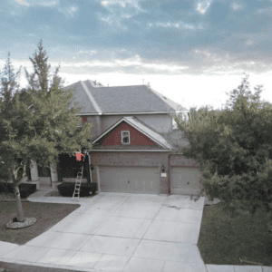 Front view of suburban home driveway and roof evaluated by Dolan Roofing & Construction in Leon Valley, Texas for roofing services