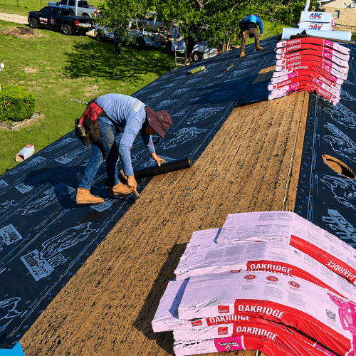 Roofing crew installing underlayment and shingles on a residential roof, supporting the best roofing company San Antonio service in San Antonio by Dolan Roofing & Construction.