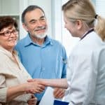 Elderly couple consulting with a healthcare professional, representing elder law services, estate planning, and legal assistance for seniors.