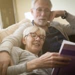 Compassionate elderly couple reading together, showcasing trust and support, family law and estate planning concepts.