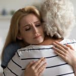 Caregiver and emotional support, comforting elderly woman, showing compassion and empathy during difficult times, home environment, mental health, family support, eldercare, compassionate assistance, legal advice for families.