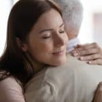 Comforting hug between a young woman and an elderly man, symbolizing compassionate legal support and trust in estate planning or personal injury cases.