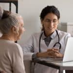 Senior woman consulting with a female doctor in a medical office, healthcare and medical consultation scene.