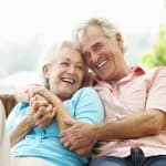 Elderly couple smiling and laughing together outdoors, representing senior care and legal support for elderly rights.
