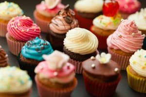 Cupcakes with colorful frosting and sprinkles, celebration desserts, sweet treats, party baked goods, festive cupcakes, dessert decoration, tasty baked sweets, colorful cupcake display, celebration cupcakes, delicious frosting cupcakes.