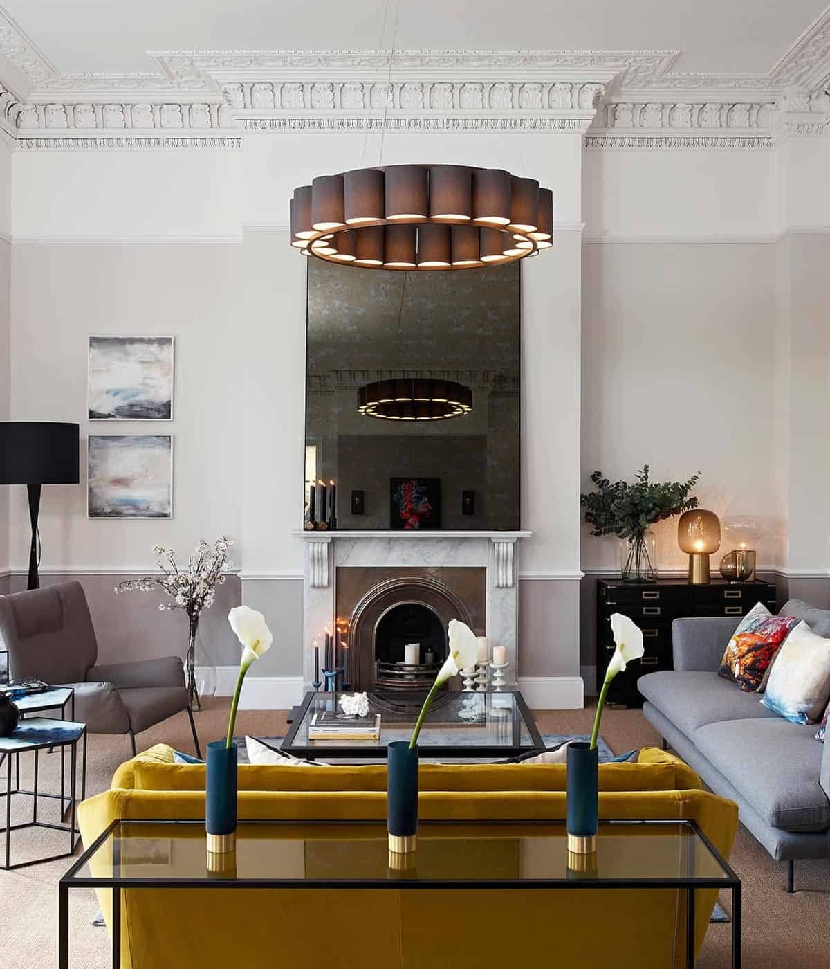 Stylish living room with contemporary furnishings, minimalist art, and statement lighting from Furnish Studio.