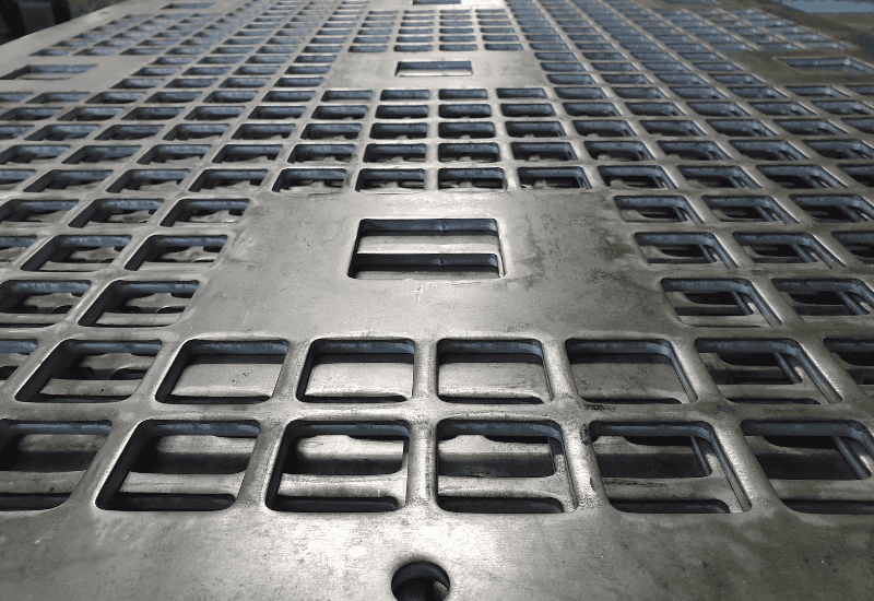 Heavy perforated metal used for industrial purposes - close up of square perforations
