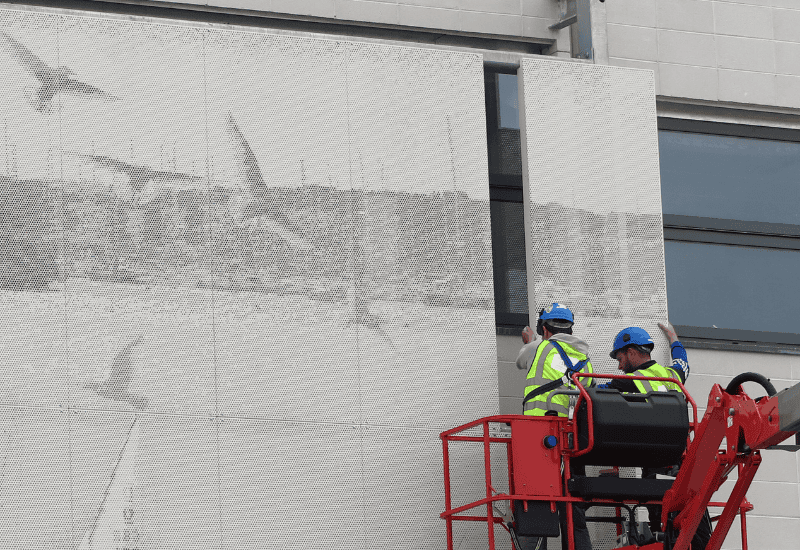 Perforated Metal - images (picture Perf) used as sunshades, image of men installing the panels