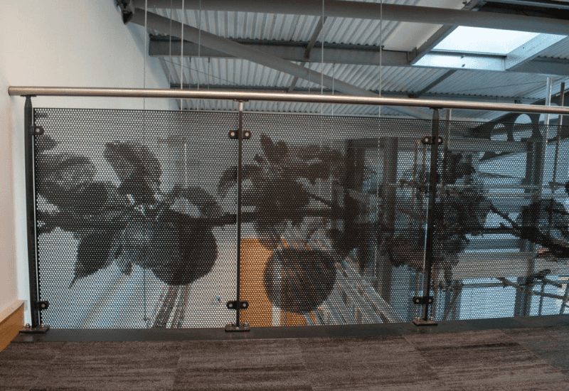 Perforated metal - picture perf of foliage into balustrade infill panel used in an interior setting