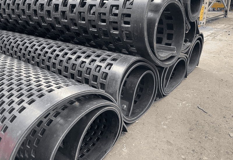 Perforated rubber mats rolled up in dispatch with square perforations