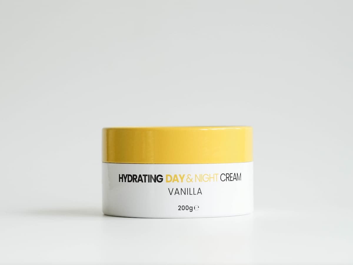 Hydrating tallow skincare day and night cream with vanilla scent in a white and yellow jar.