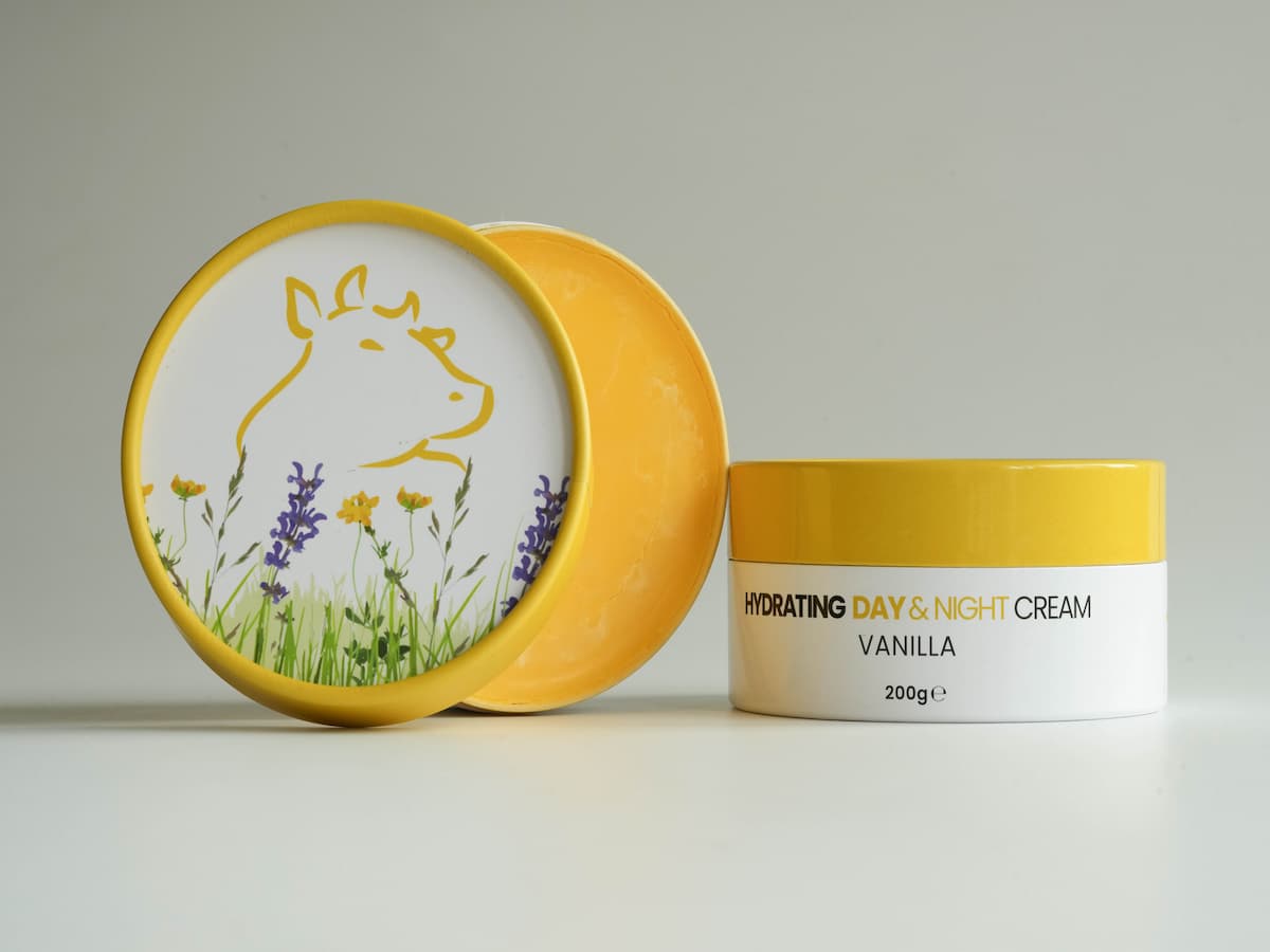 Tallow skincare cream with organic ingredients, featuring a cow illustration and floral design.