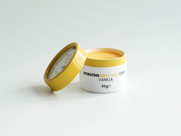 Hydrating vanilla tallow skincare cream in a yellow and white jar with a clock lid.