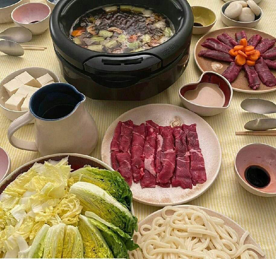 Organic tallow skincare ingredients with fresh vegetables and broth setup.