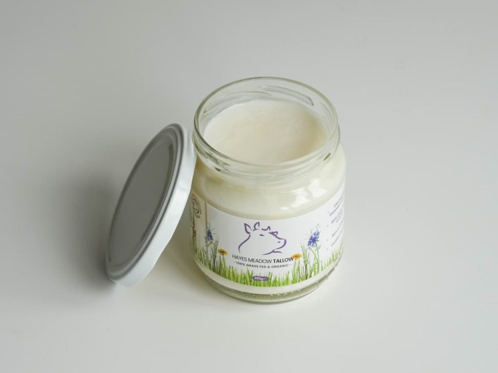 Applying Hayes Meadow certified organic grass-fed beef tallow on skin.