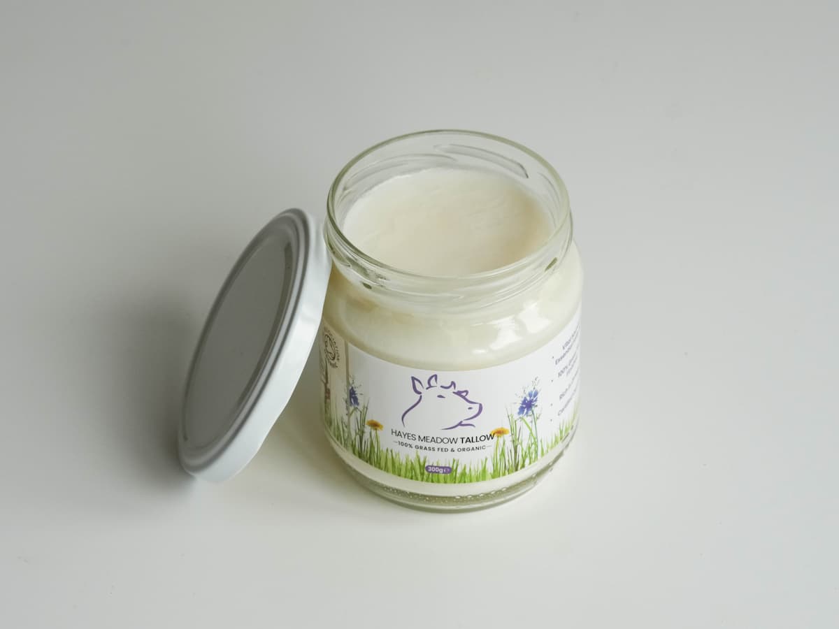 Applying Hayes Meadow certified organic grass-fed beef tallow on skin.
