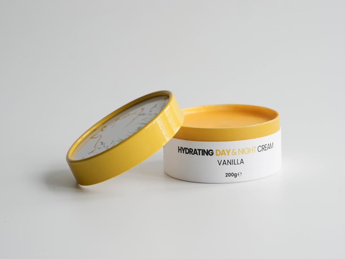Hydrating tallow skincare cream with vanilla scent in a yellow and white jar.