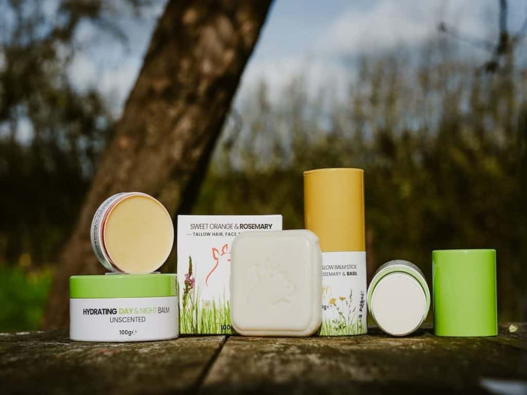 Organic tallow skincare products outdoors with natural background.