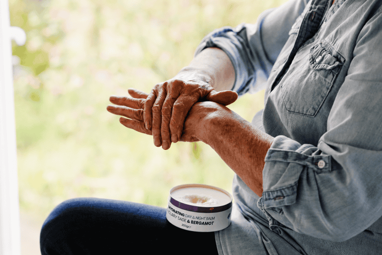 Hands applying Hayes Meadow Clary Sage & Bergamot Day & Night Tallow Skin Balm
