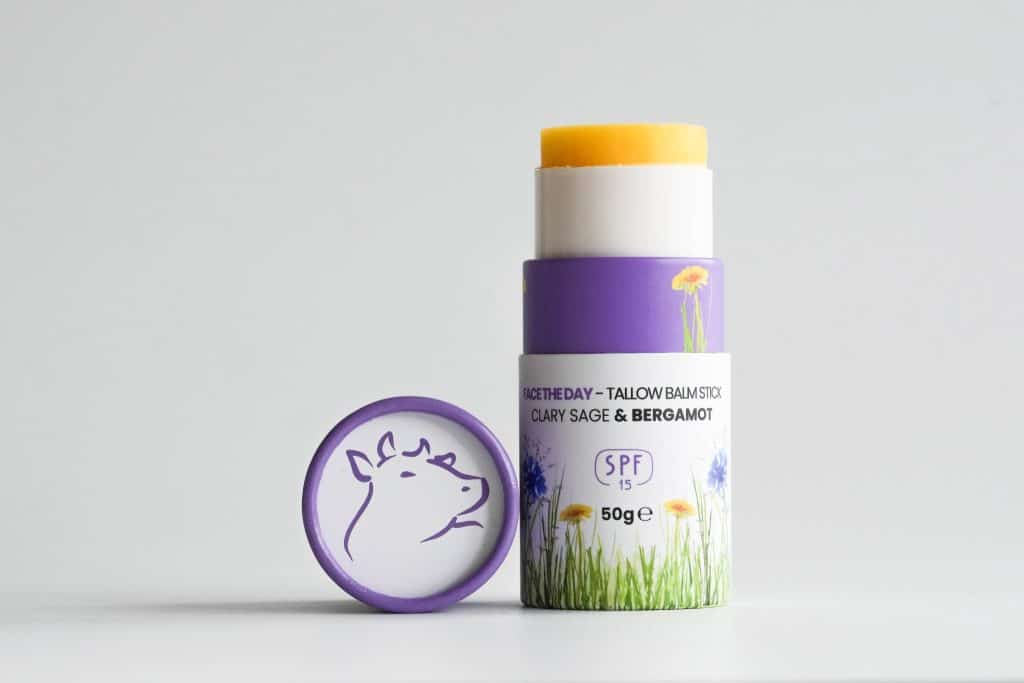 Purple SPF 15 tallow balm stick with floral pattern, upright and clearly showing the product.