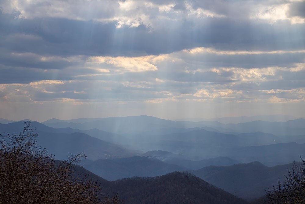 USA Destination Dupes: Alternatives to Popular Travel Spots Smoky Mountain National Park - Majestic view of the mountains, adorned with lush greenery, showcasing the serene beauty of one of America's most iconic national parks. A tranquil and picturesque destination for nature enthusiasts and outdoor adventurers.