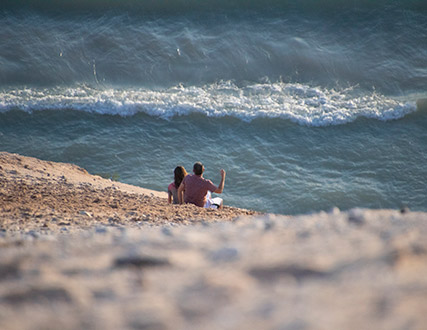 Contact Sleeping Bear Dunes- Taking a break climbing up the big dune