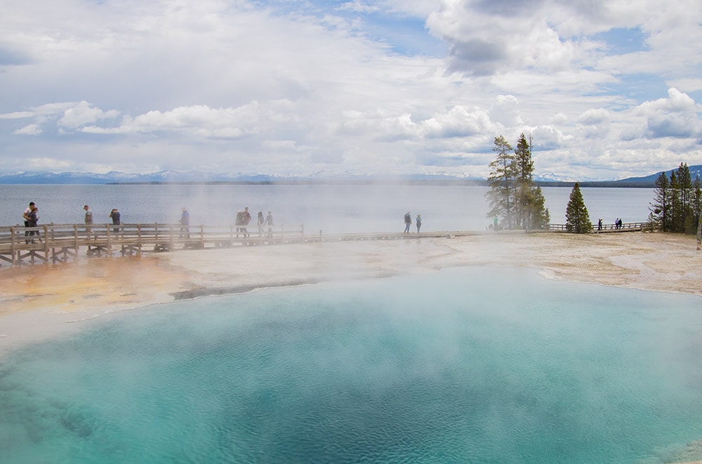 20 Easy Hikes In Yellowstone National Park You Don’t Want to Miss A view of the mountains and Yellowstone Lake from Geyser Basin Trail.