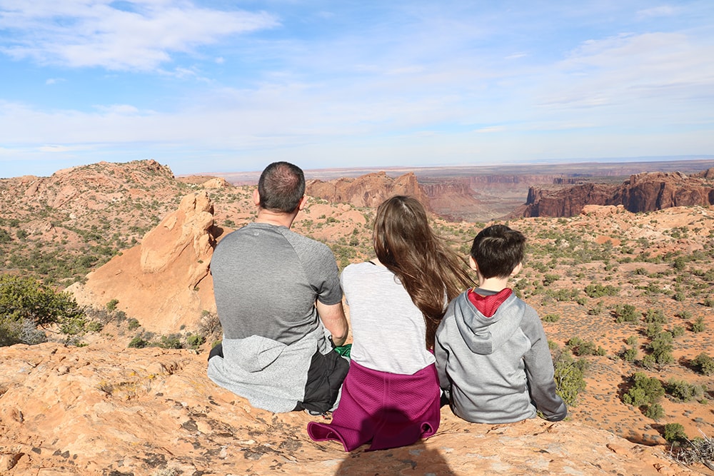 Utah National Parks Road Trip – The Perfect Itinerary Dad & kids taking in the view at Canyonlands National Park