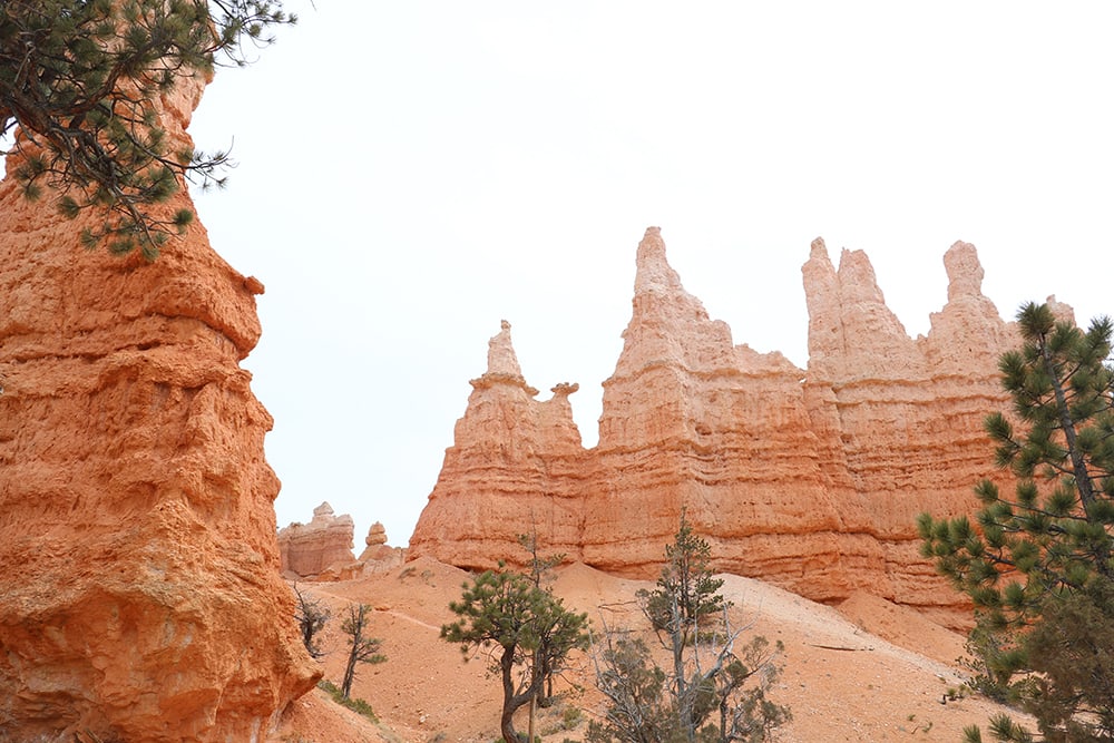 USA Destination Dupes: Alternatives to Popular Travel Spots Panoramic view of Bryce Canyon National Park with iconic hoodoos and vibrant rock formations under a clear blue sky, showcasing the breathtaking natural beauty of this renowned destination.