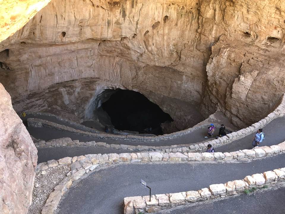 Cheap Spring Break Trips For Families In The U.S. A view from the entrance into Carlsbad Caverns. It is a winding stone path that goes down into the cave.