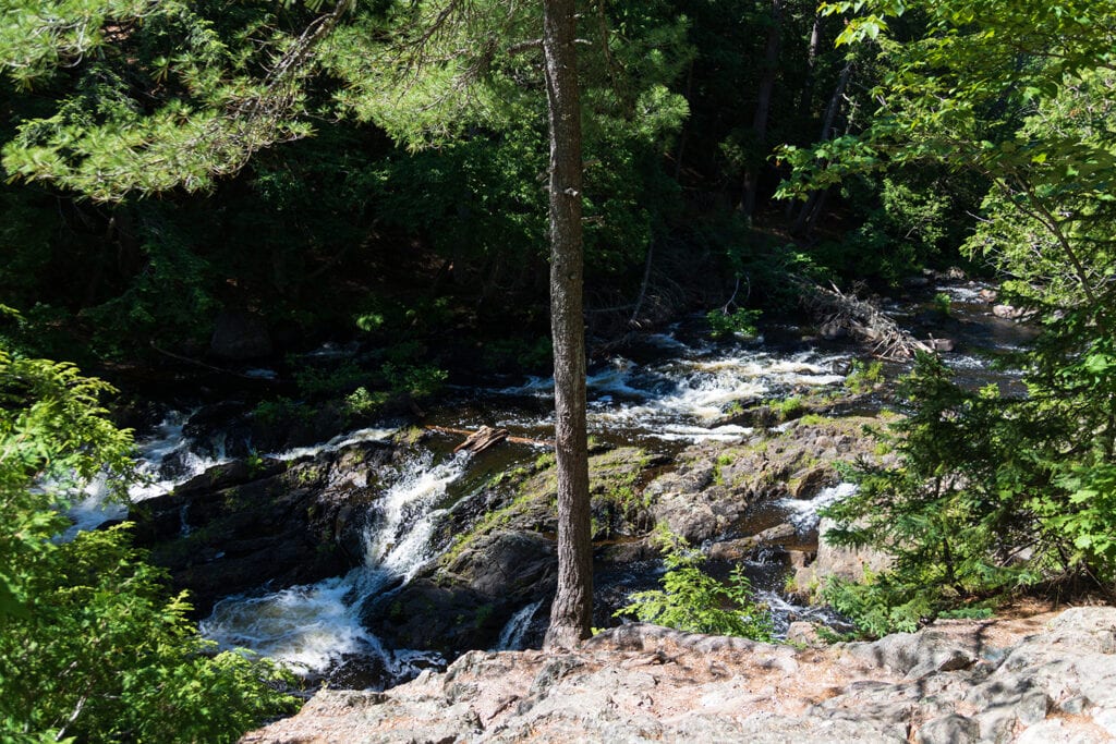 Explore the Natural Beauty of Dead River Falls In Marquette The first drop of Dead River Falls. A small rocky waterfall.