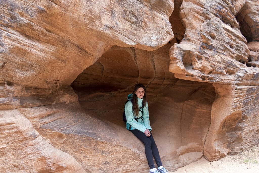 Zion National Park: The Best Easy Hikes for Outdoor Lovers Girl sitting in a small cave at Zion National Park