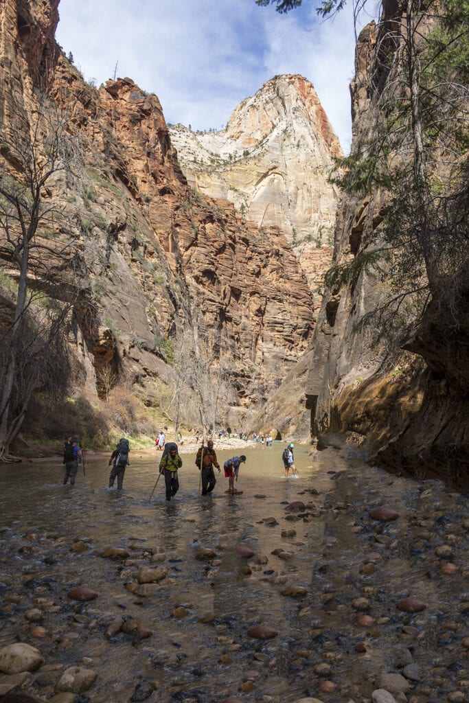 Zion National Park: The Best Easy Hikes for Outdoor Lovers Hikers walking along the flowing river on Zion Narrows Riverside Trail. One of zion national park's easy hikes