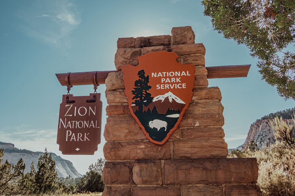 Zion National Park – Fees, Passes & How To Get In Free A view of the Zion National Park sign