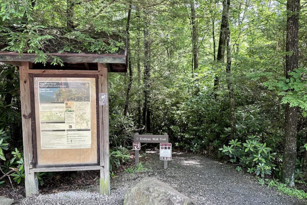 Endless Wall Trail Guide: Trail Tips, Parking, and Scenic Overlooks Nuttall Trailhead sign at the Endless Wall Hike, marking the starting point surrounded by trees and a well-maintained path.