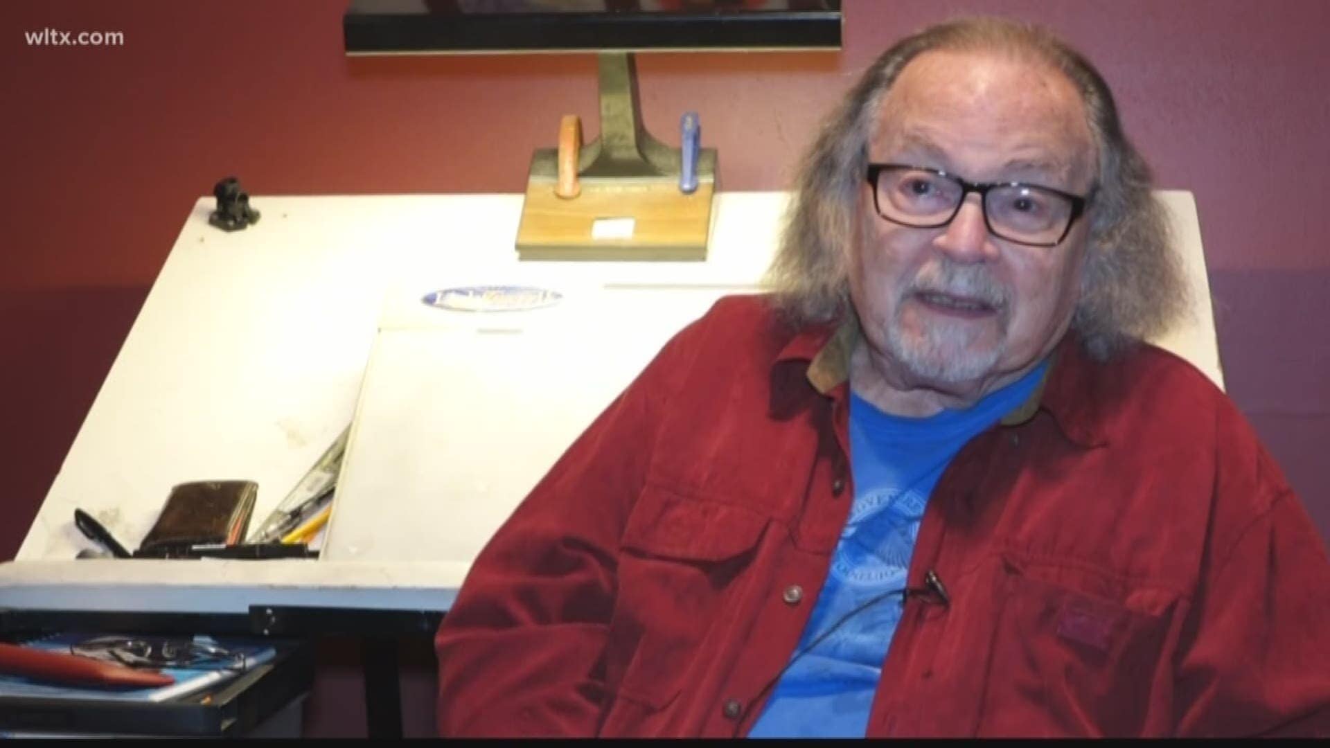 Vic Carrabotta, comic book artist, sitting in front of his drawing board.