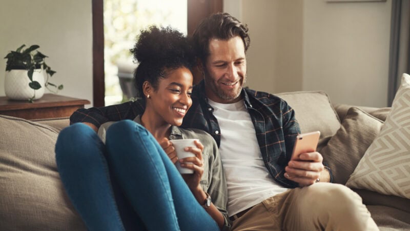 Young couple sat on sofa