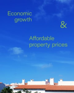 White houses with red tiles roofs under a blue sky