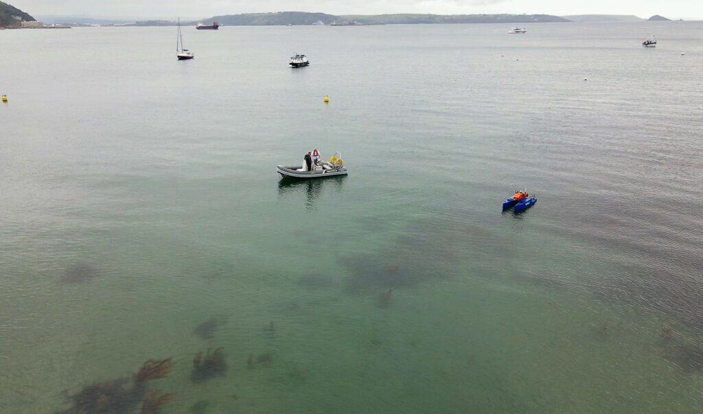 Dinghy and HydroSurv Uncrewed Surface Vessel (USV) on the sea monitoring sea grass