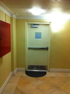Misstep caused fall while exiting door without warning sign