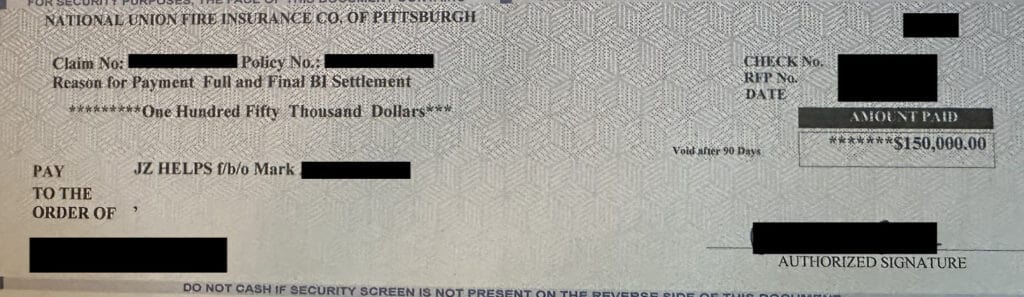 Redacted insurance settlement check for $150,000 from National Union Fire Insurance Co. for a car accident claim.