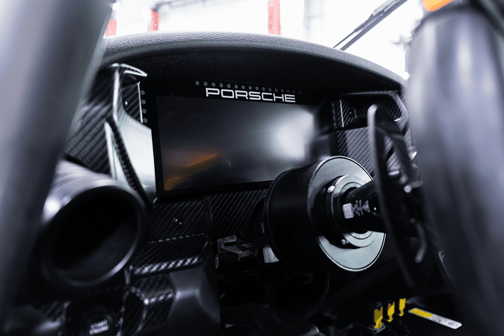 Close-up of Porsche 911 Cup Car dashboard and steering wheel.