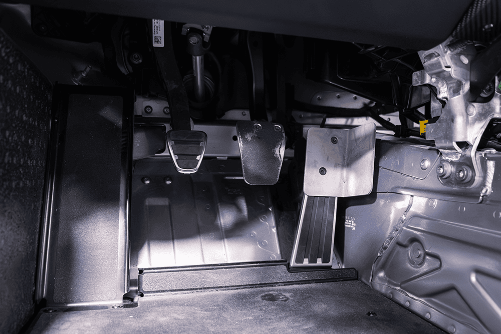 Close-up of racing pedals and footwell in a Porsche 911 Cup Car 992.
