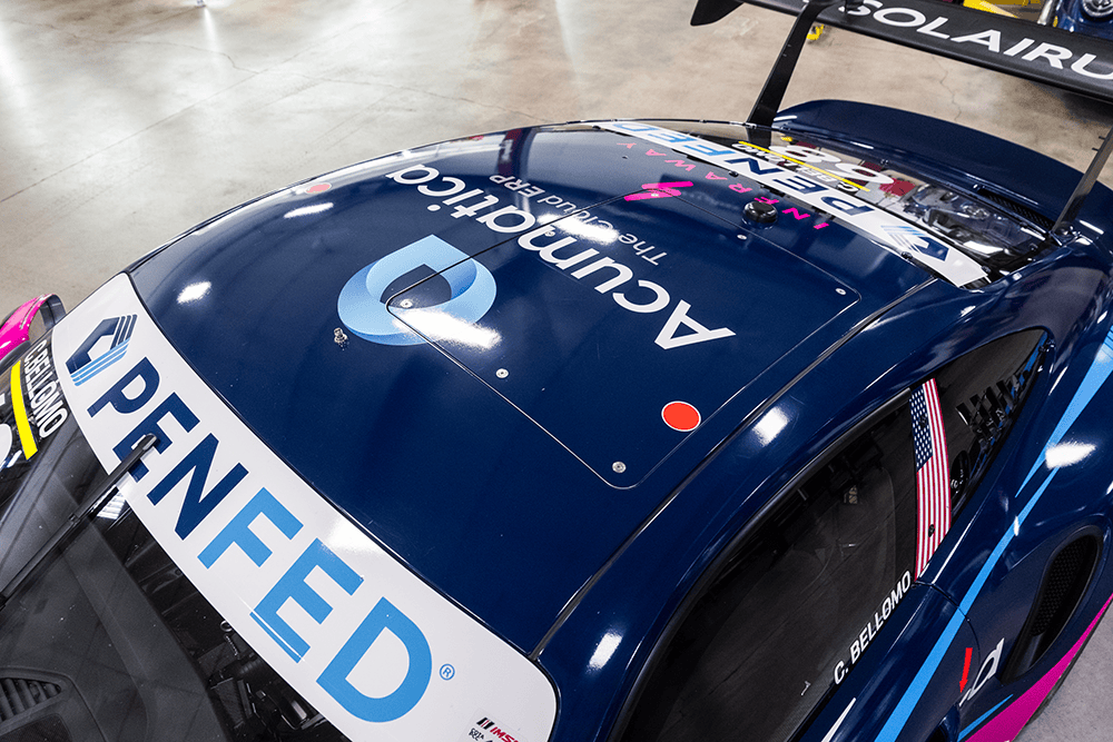 Close-up of Kellymoss Porsche 911 Cup Car 992 with sponsor logos and racing decals.
