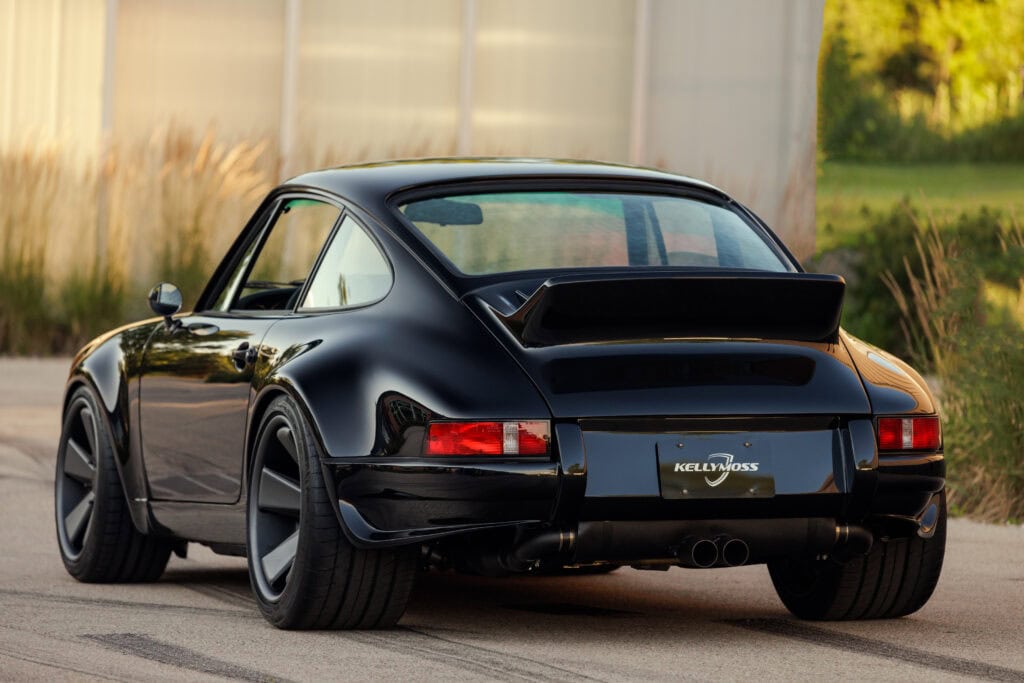 Black Porsche 964 with wide rear wing and custom wheels from Kellymoss.