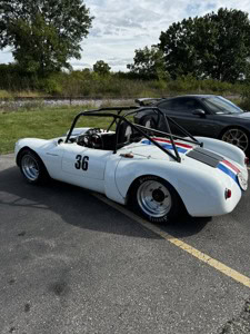Vintage 1966 Porsche 550 Spyder with racing stripes and number 36.